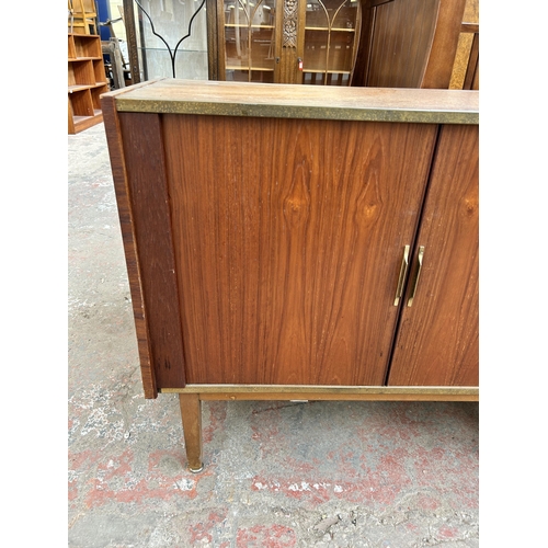 140 - A mid 20th century teak tambour door media cabinet