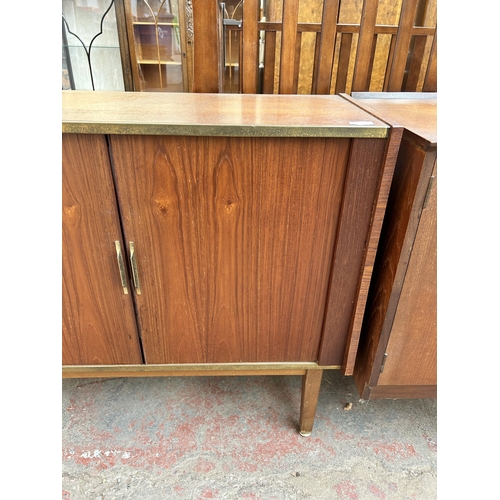 140 - A mid 20th century teak tambour door media cabinet