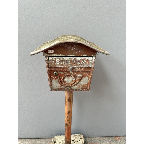 143 - A Dutch red painted cast metal pedestal letterbox - approx. 103cm high