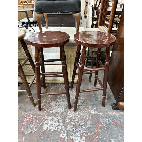 150 - Five beech bar stools, four circular top and one green fabric upholstered