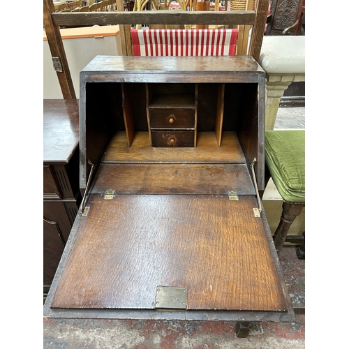 151 - A 1930s oak bureau with fall front and single drawer