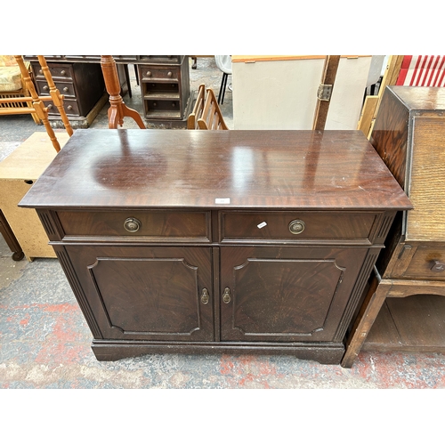 153 - A Regency style mahogany sideboard with two drawers and two cupboard doors