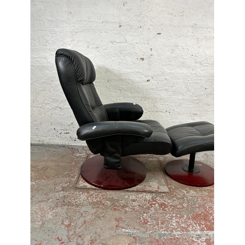 154 - A Stressless style black leather swivel reclining armchair and stool