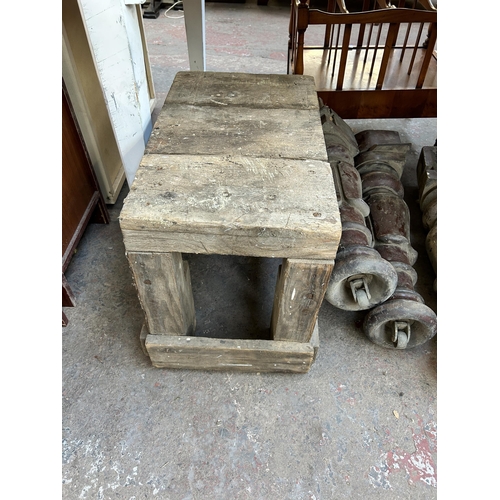 170 - Five items, three Victorian mahogany dining table legs and two early 20th century pine saw benches