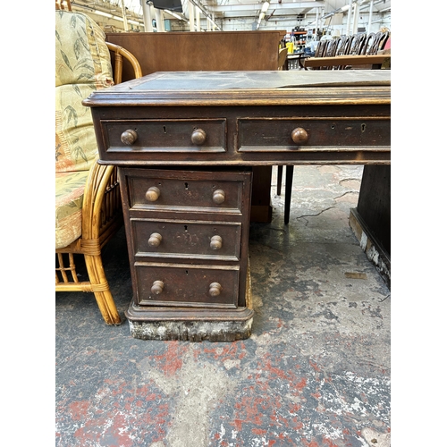 177 - A Victorian oak pedestal desk with black writing surface