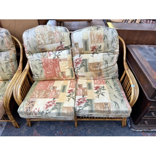 178 - A wicker and cane four piece conservatory suite comprising two seater sofa, two armchairs and glass ... 