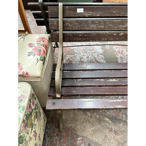 18 - A cast iron and wooden slatted garden bench