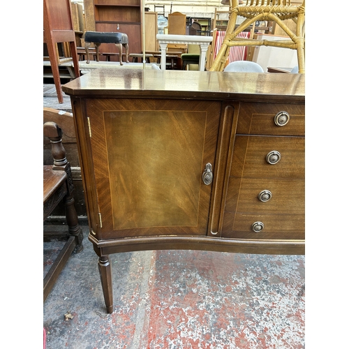 185 - A Regency style mahogany sideboard with two outer cupboard doors and four central drawers