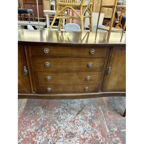 185 - A Regency style mahogany sideboard with two outer cupboard doors and four central drawers