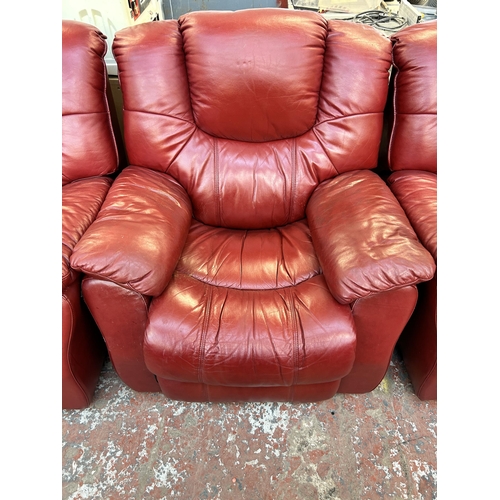 188 - A modern red leather reclining three piece lounge suite comprising three seater sofa and two armchai... 