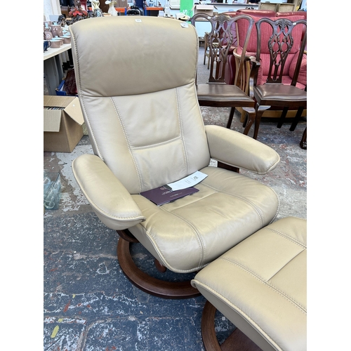 194 - A HSL Hamilton Grande Hudson Latte leather and walnut swivel reclining armchair and stool - RRP £840