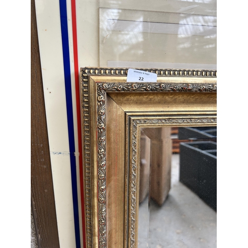 22 - A gilt framed bevelled edge wall mirror - approx. 135cm x 104cm