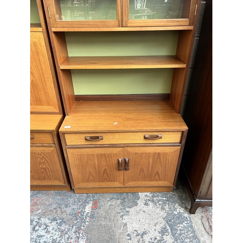 32 - A 1970s G Plan teak bookcase with two upper glazed doors, single drawer and two lower cupboard doors... 