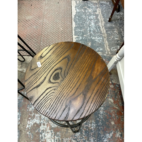 42 - A pair of industrial style oak and grey metal kitchen bar stools - approx. 75cm high x 33cm diameter