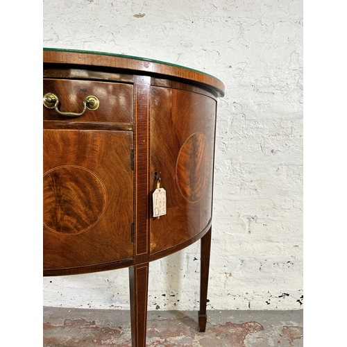 44 - An early 20th century Regency style inlaid mahogany bow fronted sideboard with two outer cupboard do... 