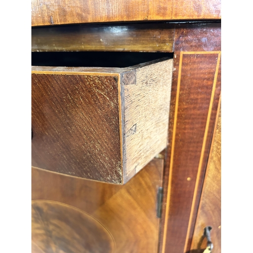 44 - An early 20th century Regency style inlaid mahogany bow fronted sideboard with two outer cupboard do... 