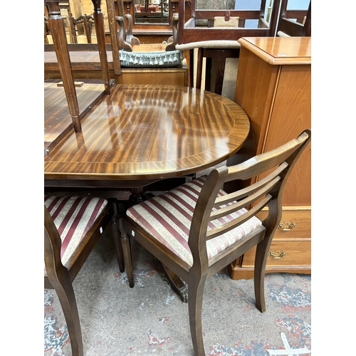 58 - A Regency style mahogany twin pedestal extending dining table and four chairs