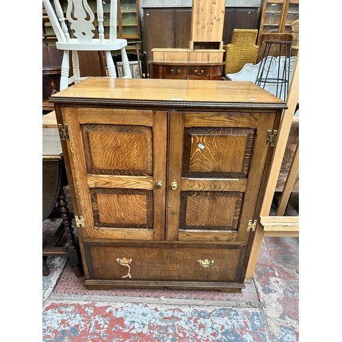 62 - A Georgian style oak TV cabinet with two doors and single drawer