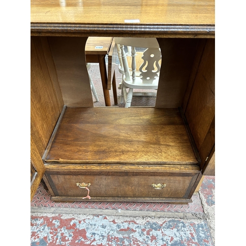 62 - A Georgian style oak TV cabinet with two doors and single drawer