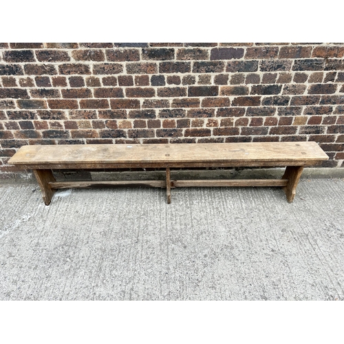 79 - An early 20th century oak bench - approx. 48cm high x 25cm wide x 244cm long