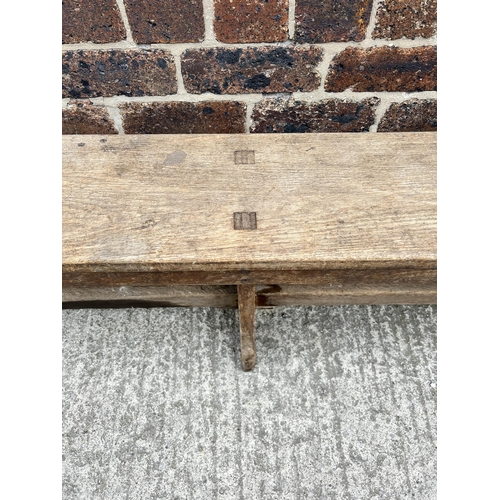 79 - An early 20th century oak bench - approx. 48cm high x 25cm wide x 244cm long