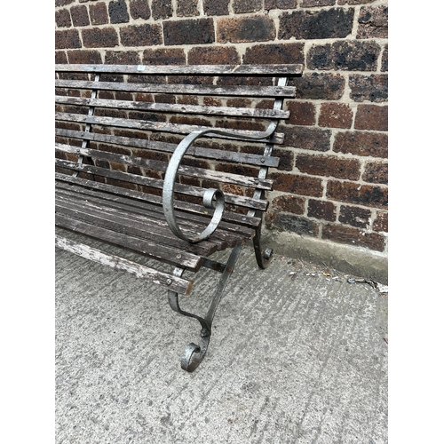 82 - A wrought iron and wooden slatted garden bench - approx. 78cm high x 183cm wide x 62cm deep