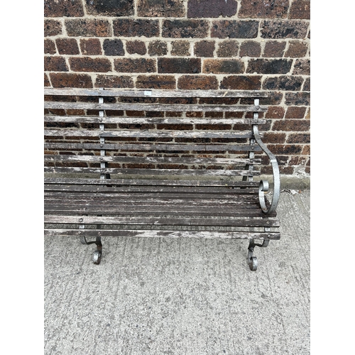 82 - A wrought iron and wooden slatted garden bench - approx. 78cm high x 183cm wide x 62cm deep