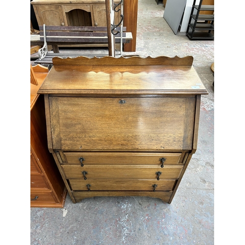 84 - An early 20th century walnut bureau with three drawers and fall front