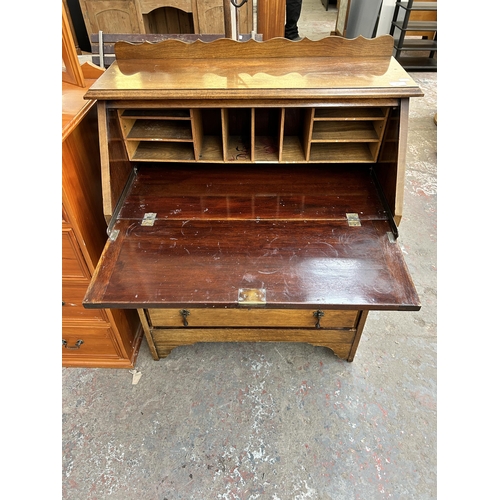 84 - An early 20th century walnut bureau with three drawers and fall front