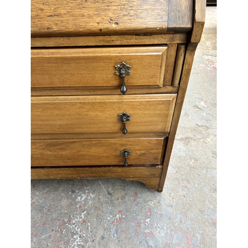 84 - An early 20th century walnut bureau with three drawers and fall front