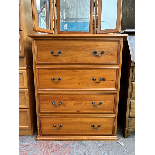 85 - A pine chest of four drawers with dressing table mirror