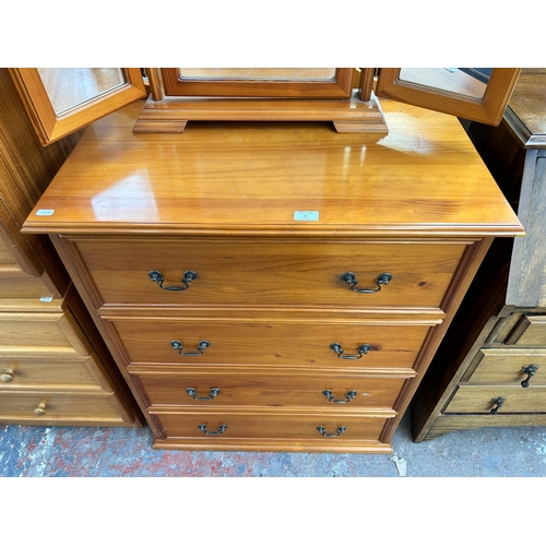 85 - A pine chest of four drawers with dressing table mirror