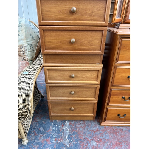 86 - A pair of 1980s G Plan teak bedside chests of three drawers