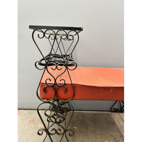 87B - A wrought iron and red vinyl telephone table with glass top