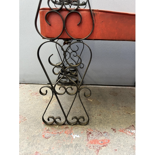 87B - A wrought iron and red vinyl telephone table with glass top