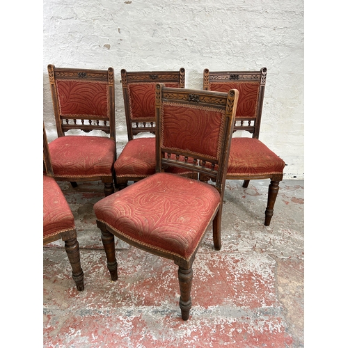 94 - Six late Victorian carved oak and red fabric upholstered dining chairs