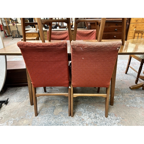 97 - A mid 20th century Alfred Cox walnut rectangular extending dining table and six chairs