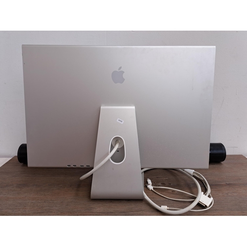 606 - Two items, one Apple Cinema HD display together with one CXT Trust Gaming promotional material