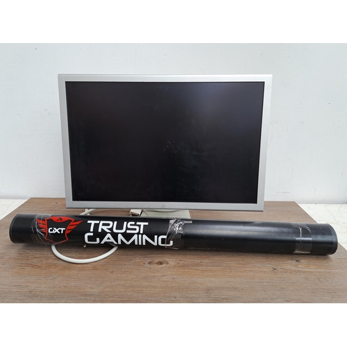 606 - Two items, one Apple Cinema HD display together with one CXT Trust Gaming promotional material