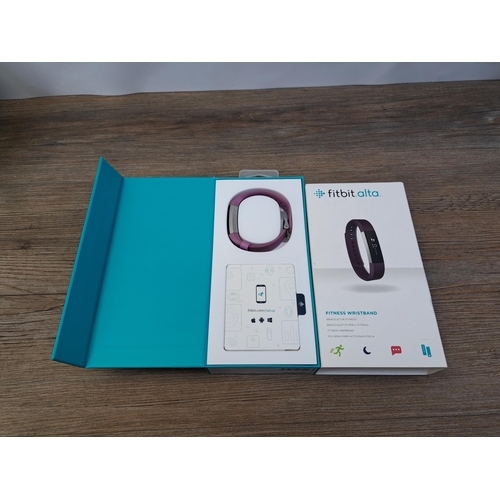 607 - A collection of fitness trackers to include boxed FitBit Alta, Garmin Forerunner 305, Garmin Forerun... 