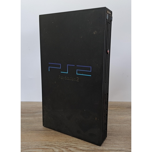 631 - A box containing a Sony PlayStation 2, games and accessories