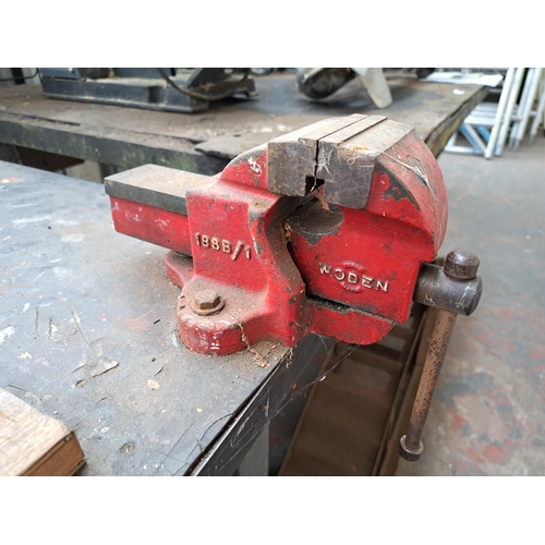 721 - A metal and fibre board topped work bench with two drawers together with mounted Clarke metalworker ... 