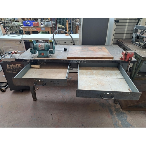 721 - A metal and fibre board topped work bench with two drawers together with mounted Clarke metalworker ... 