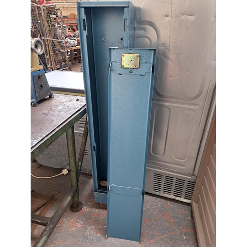 728 - An industrial cast metal gun cabinet - approx. 135cm high x 23cm wide x 21cm deep