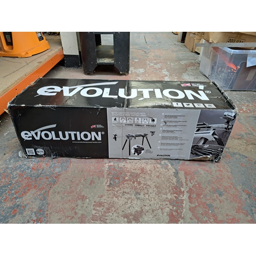 765 - A boxed Evolution mitre saw stand with instruction manuals and adjustable work support arms