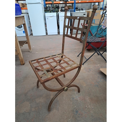 816 - A set of six wrought iron X framed garden chairs