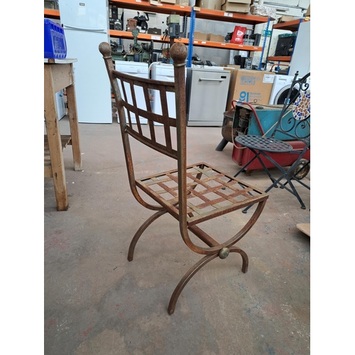 816 - A set of six wrought iron X framed garden chairs