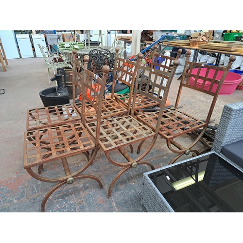 816 - A set of six wrought iron X framed garden chairs