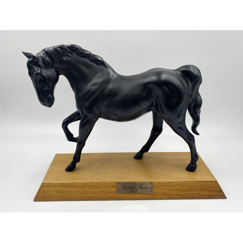 261 - Two matte black ceramic horse figurines, one Royal Doulton Spirit of Freedom on wooden plinth and on... 