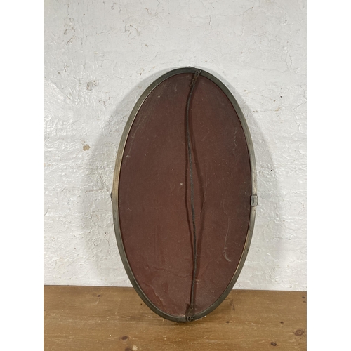 214 - An early/mid 20th century brass framed oval bevelled edge wall mirror, RD No. 692703 - approx. 44cm ... 